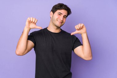 Mor arka planda izole edilmiş genç adam gururlu ve kendinden emin hissediyor, örnek olarak..