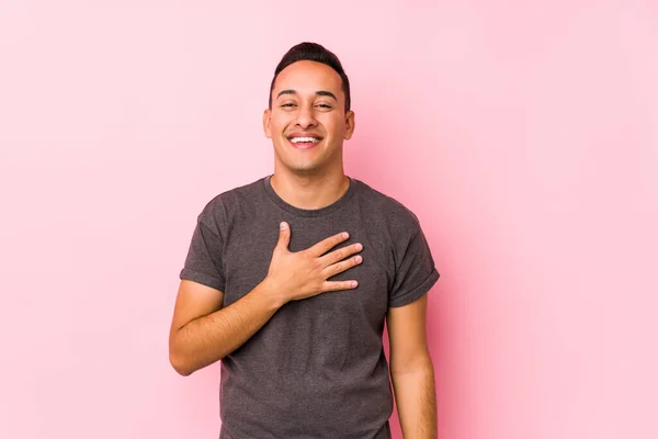 Yooung Latino Posando Fondo Rosa Ríe Voz Alta Manteniendo Mano — Foto de Stock