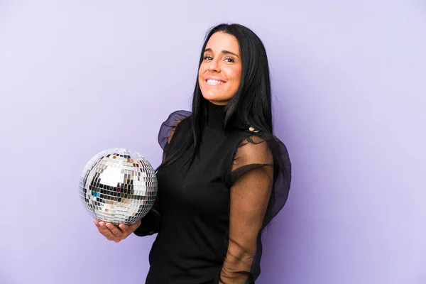 Woman Holding Ball Party Isolated Purple Background Looks Aside Smiling — Stock Photo, Image