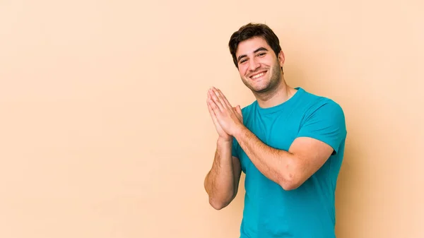 Young Man Isolated Beige Background Feeling Energetic Comfortable Rubbing Hands — Stock Photo, Image