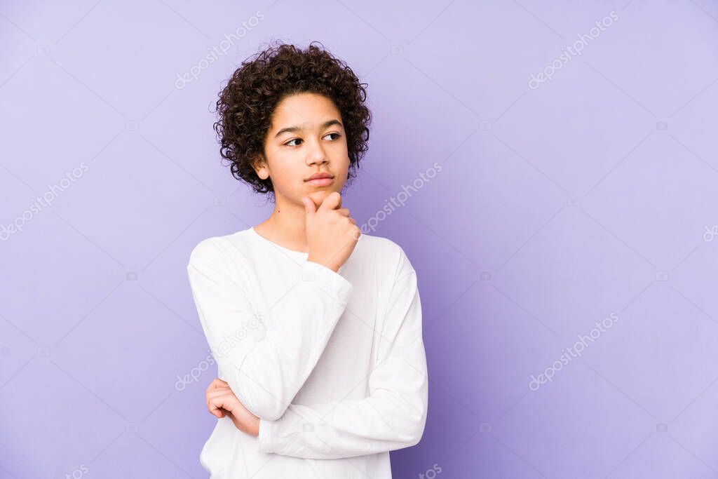 African american little boy isolated looking sideways with doubtful and skeptical expression.