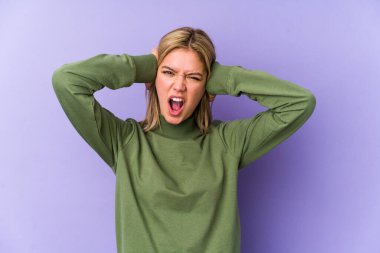 Sarışın, beyaz tenli, yalıtılmış kulakları kulaklarıyla kapatan bir kadın yüksek sesli sesler duymamaya çalışıyor..