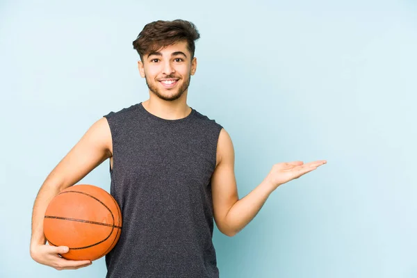 Young Arabian Man Playing Basket Isolated Showing Copy Space Palm — Stock Photo, Image