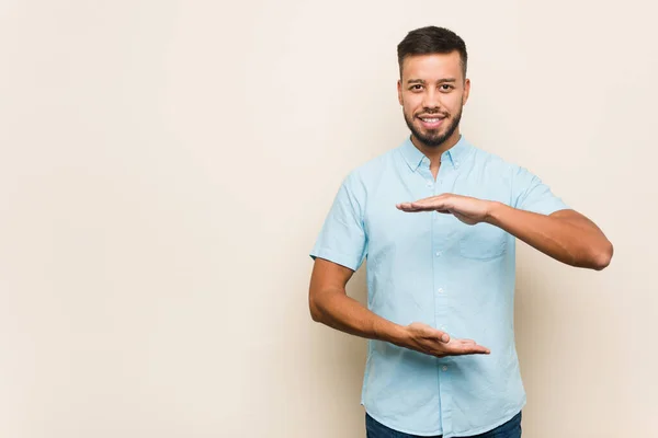 Young South Asian Man Holding Something Both Hands Product Presentation — Stock Photo, Image