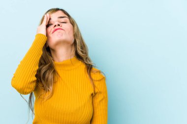 Sarışın, beyaz bir kadın bir şey unutmuş. Alnına avuç içiyle vurup gözlerini kapatıyor..