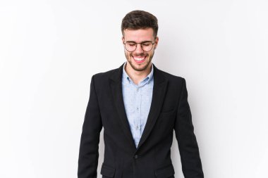 Beyaz arka planda poz veren beyaz tenli genç beyaz iş adamı Kafkasyalı genç iş adamı gülüyor ve gözlerini kapıyor, rahatlamış ve mutlu hissediyor..
