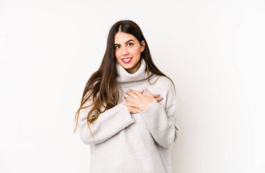 Beyaz arka planda izole edilmiş beyaz bir kadın, dost canlısı bir ifadeye sahip, avuçlarını göğsüne bastırıyor. Aşk konsepti.