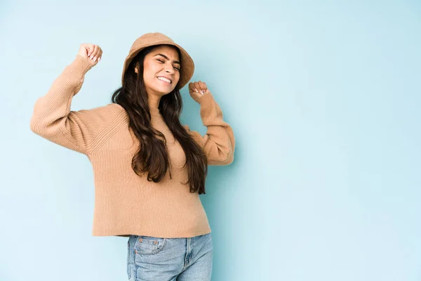 Giovane Donna Indiana Indossa Cappello Isolato Sfondo Blu Alzando Pugno — Foto Stock