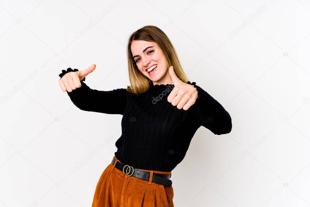Young caucasian woman isolated on white background raising both thumbs up, smiling and confident.