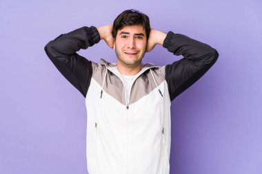 Mor arka planda izole edilmiş genç adam öfkeyle bağırıyor.