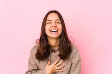 Genç, melez, Latin bir kadın. Kahkahalar atıyor, elini göğsüne koyuyor..