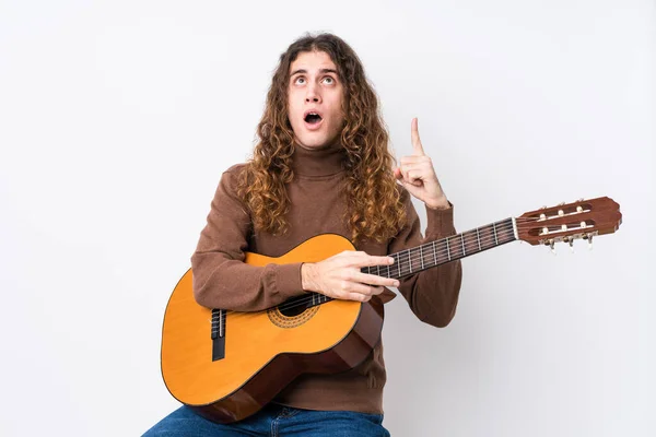 Young Caucasian Man Playing Guitar Isolated Pointing Upside Opened Mouth — Stock Photo, Image