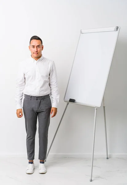 Young Latin Coaching Man Whiteboard Isolated Confused Feels Doubtful Unsure — Stock Photo, Image