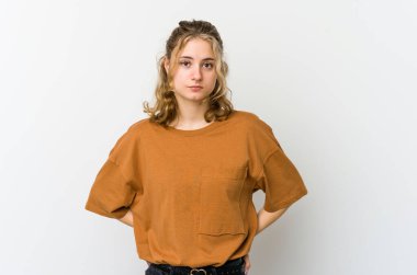 Beyaz arka plandaki genç beyaz kadın üzgün, ciddi yüz, mutsuz ve hoşnutsuz..