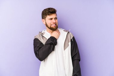 Mor arka planda izole edilmiş genç bir adam kafasının arkasına dokunuyor, düşünüyor ve bir seçim yapıyor..