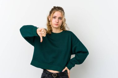 Beyaz arka planda genç beyaz kadın baş parmağını aşağı gösteriyor, hayal kırıklığı konsepti..