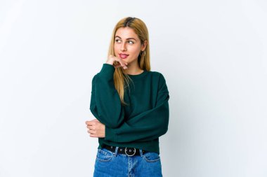 Beyaz arka planda izole edilmiş genç sarışın kadın rahatlamış fotokopi odasına bakan bir şey düşünüyor..