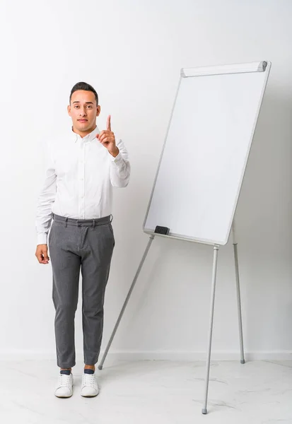 Young Latin Coaching Man Whiteboard Isolated Showing Number One Finger — Stock Photo, Image