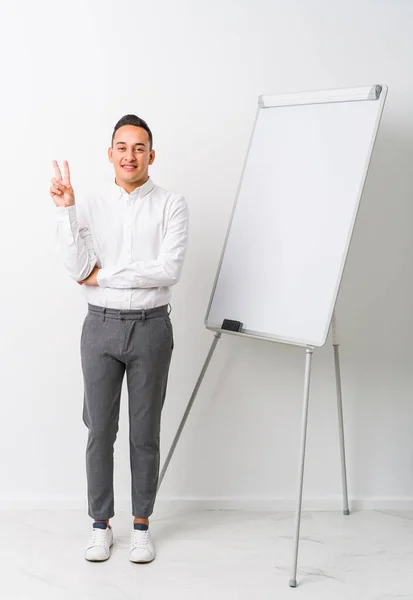 Young Latin Coaching Man Whiteboard Isolated Showing Number Two Fingers — Stock Photo, Image