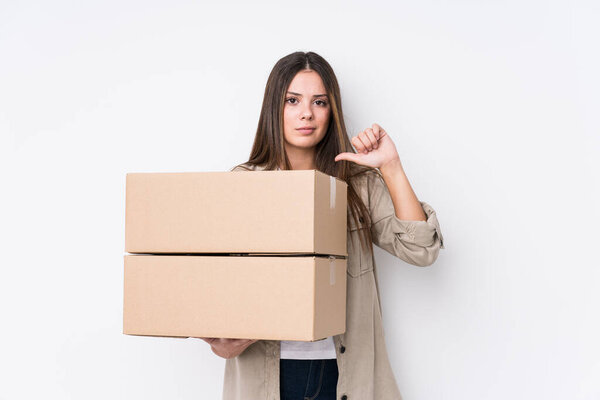 Young caucasian woman moving to a new home showing a dislike gesture, thumbs down. Disagreement concept.