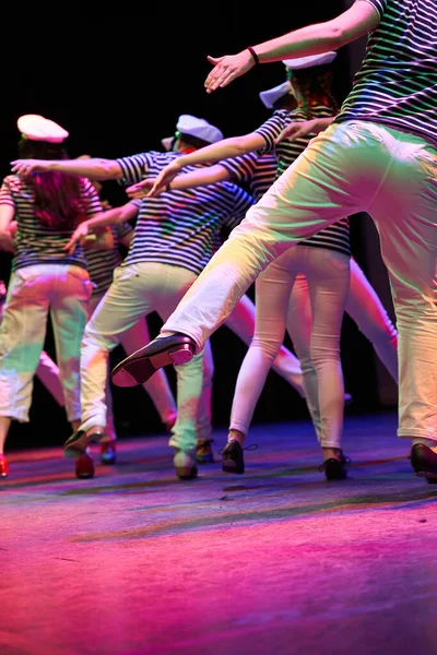 Group of tap dancers performing in sailor costumes on stage