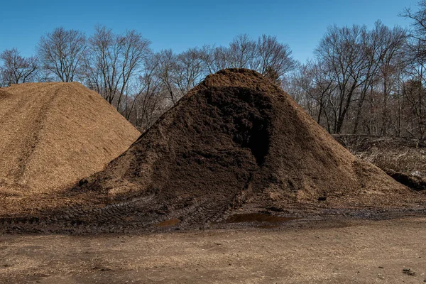 Bulk organic brown mulch mound freshly dug on the farm
