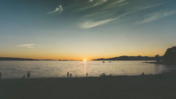 Summer sunset in British Columbia Canada. English Bay is the most popular beach for sunsets and chill in Vancouver
