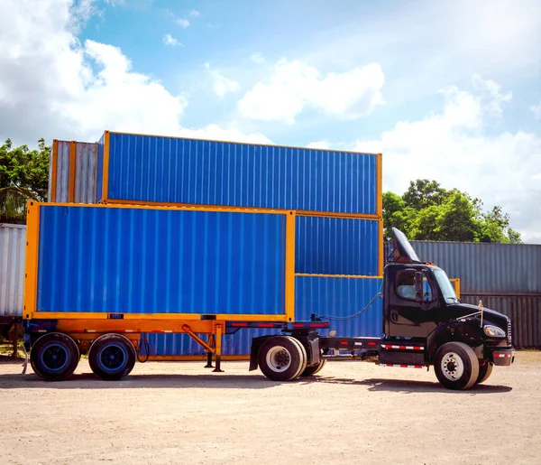 Truck moving blue container