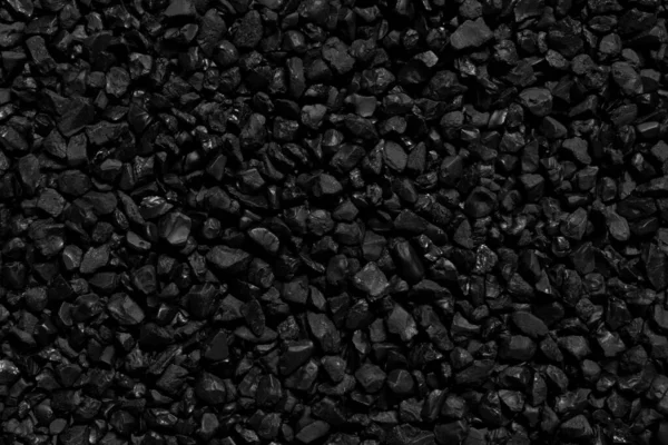 Natural fire ashes with dark black coals texture. It is a flammable black hard rocks. Space for text