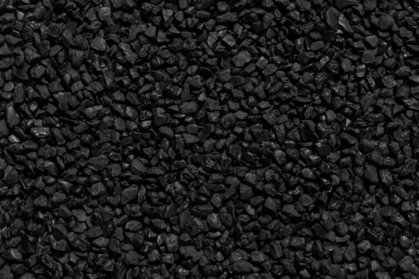 Natural fire ashes with dark black coals texture. It is a flammable black hard rocks. Space for text