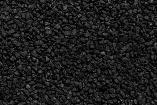 Natural fire ashes with dark black coals texture. It is a flammable black hard rocks. Space for text