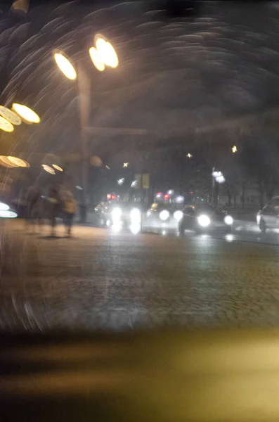 Bokeh on the wet car's wind-shield. Rainy photography with strong bokeh. Using of tilt-shift lens.