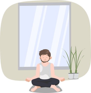 Kendini evinde rahatlatmak için meditasyon yapan bir adam.