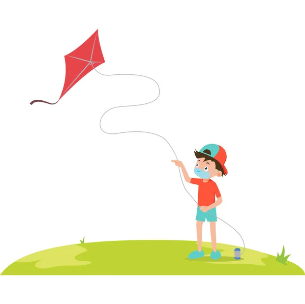 Tıbbi maske takan bir çocuk sahada uçurtma oynuyor.