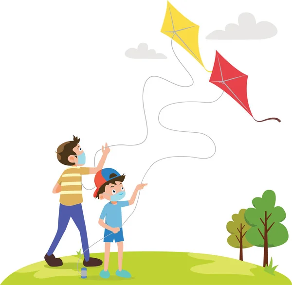 Kardeşler sahada tıbbi maske takarak uçurtma oynuyorlar.