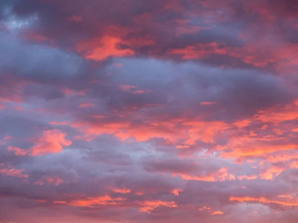 stock image Gorgeous red and orange sunset clouds against a blue sky.