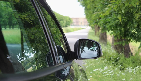 Car rearview mirror - driving in the countryside