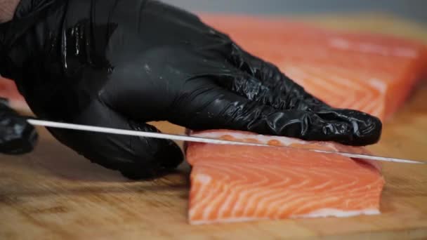 Hands Gloves Cut Red Salmon Knife Wooden Board — Stock Video