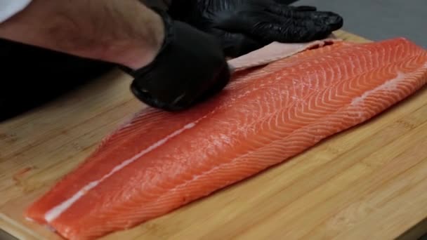 Hands Gloves Cut Red Salmon Knife Wooden Board — Stock Video