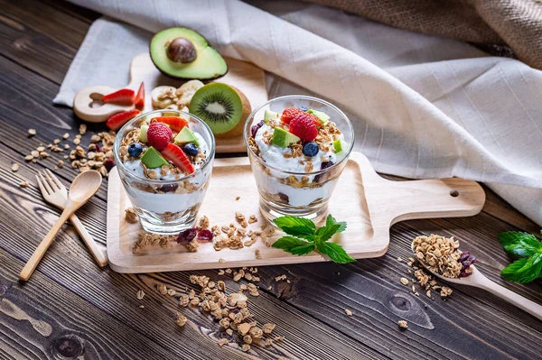 Greek Yogurt homemade with berries, avocado, banana and granola. It\'s healthy menu and low calories for people who diet. the high quality picture for artwork and graphic design