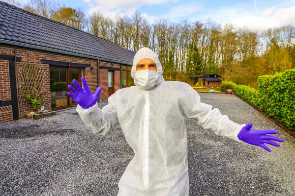 Doctor wearing antiviral protective surgical face mask and coveralls during Coronavirus pandemic worldwide crisis and lockdown in Europe, USA and China. Dangerous SARS-CoV-2 virus Epidemic.