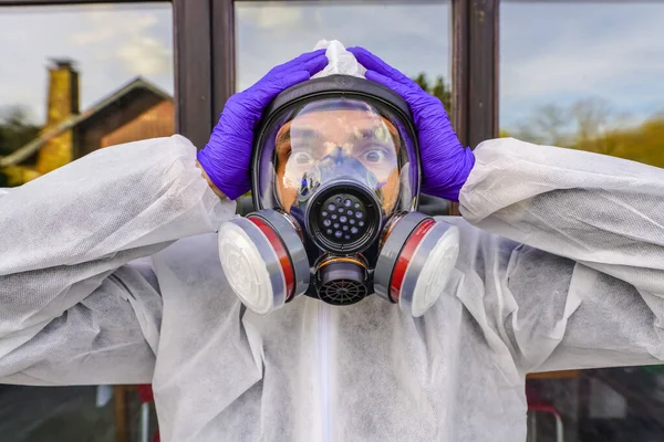 Man wearing big gas mask against Coronavirus Covid-19 contamination. Lockdown for SARS-CoV2 virus pandemic. Post apocalypse specialist breathing in anti-virus and radiation gas mask. Doomsday clothing