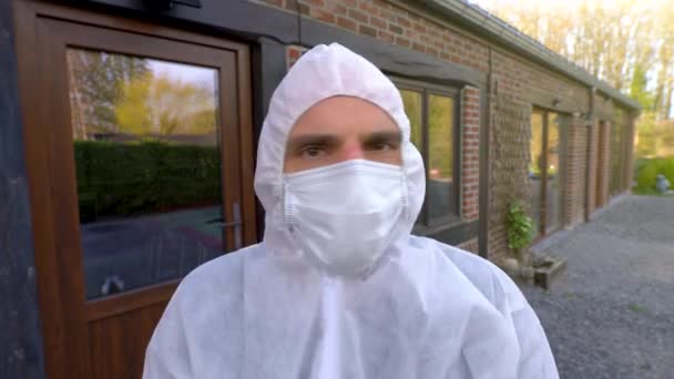 Doctor Wearing Antiviral Protective Surgical Face Mask Coveralls Showing Sign — Stock Video