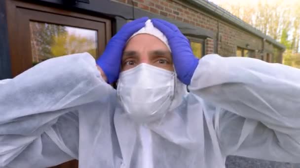 Doctor Wearing Antiviral Protective Surgical Face Mask Coveralls Showing Sign — Stock Video