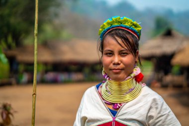Huay Pu Keng, Tayland - 22 Mart 2019: Huay Pu Keng köyünde gülümseyen uzun boyunlu Kayan Padaung kadın. Boynunda pirinçten bobinler olan güzel bir kadın portresi.