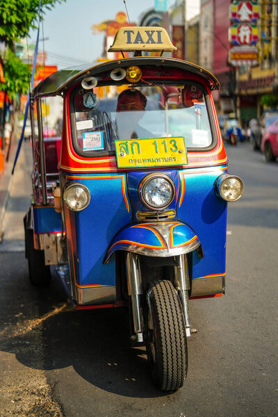 Bangkok, Thailand - March 17, 2019: Tuk tuk, auto rickshaw, famous urban transport in the streets of Bangkok, Thailand.