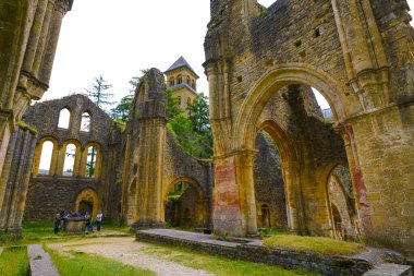 FLORENVILLE, BELGIUM - 4 Haziran 2019: Orval Abbey kalıntıları ve kilise. 1132 yılında Trappist bira Orval 'ı ve spesifik peynirleriyle bilinen Villers-Devant-Orval' da kurulan bir manastır..