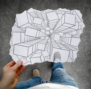 3D blocks with a strong perspective seen from above drawn on a hand held piece of paper with feet, shoes and floor in the photo background. Mixed media image. clipart
