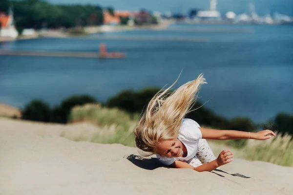 Enfant s'amuser dans les dunes de sable sur la plage — Photo