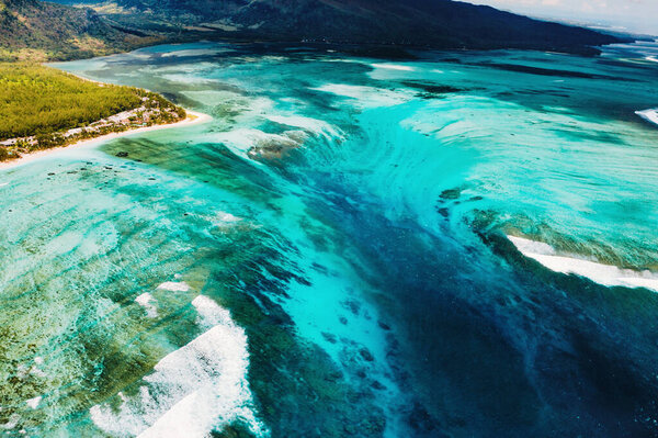 The view from the bird 's eye view of the coral reef near the mountain Le Morne Brabant, a beautiful blue lagoon and the underwater waterfall
.